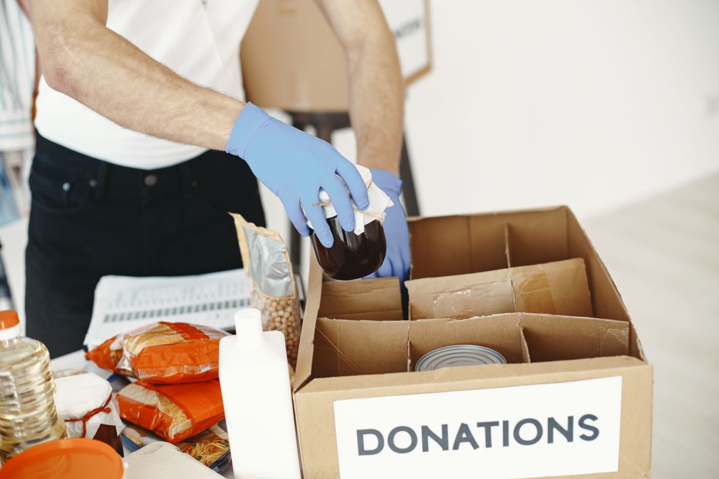 Canned goods being packed into a donations box